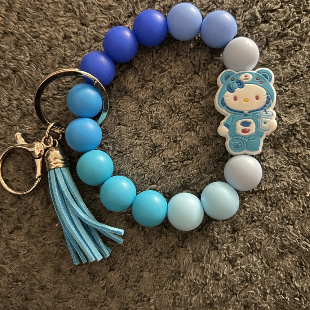 Blue hello kitty dressed as care bear wristlet